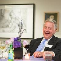 J.C. Huizenga laughing with two other guests at a table.